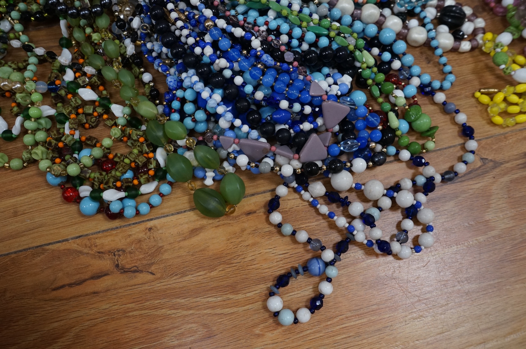 A large collection of glass bead necklaces